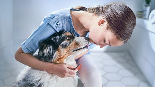 girl hugging her dog